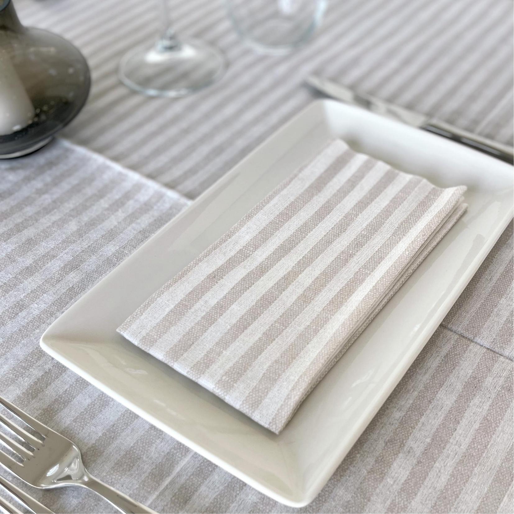 Beige and white striped compostable napkin.